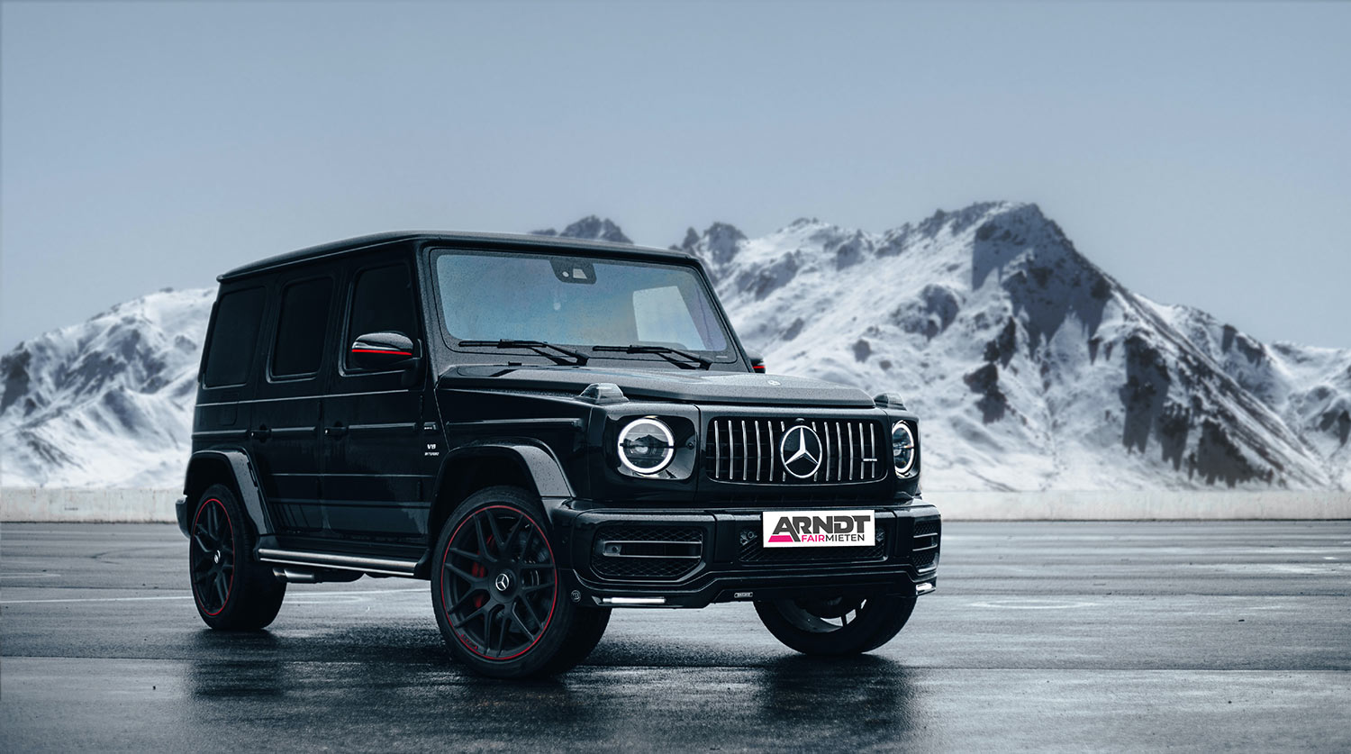 Mercedes-Benz G-Klasse AMG G63 in Schwarz vor verschneiter Bergkulisse, mieten bei Autovermietung Arndt